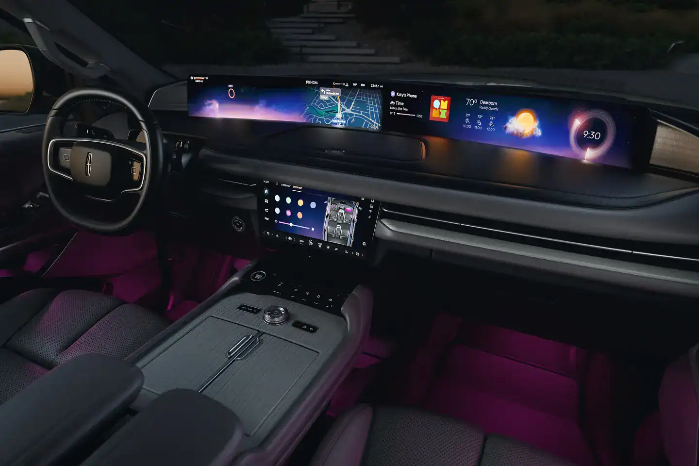 Luxury car interior with sleek dashboard, digital displays, steering wheel, and ambient lighting.